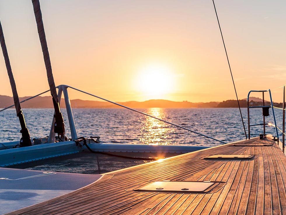 Catamaran boat, multihulls at sunset on the sea