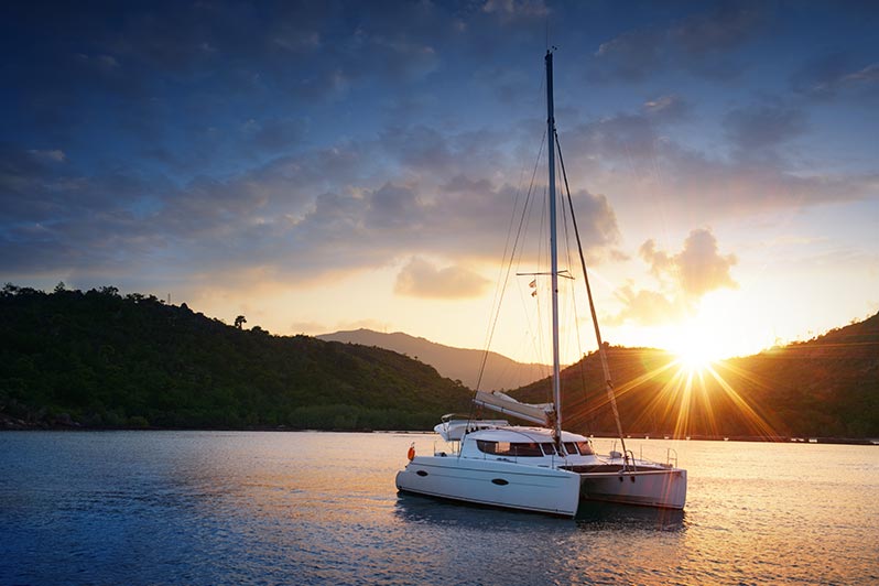 catamaran sailboat at sunset on the sea