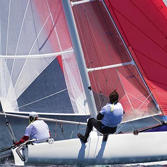 men during a regatta on a catamaran